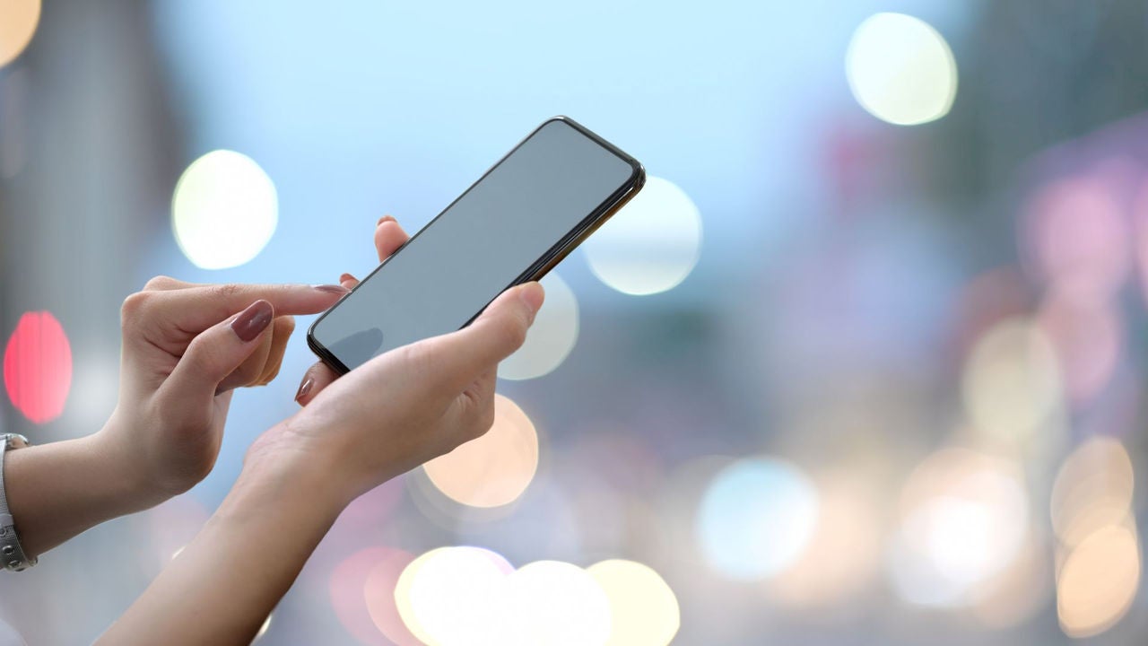 Woman holding a mobile phone. 