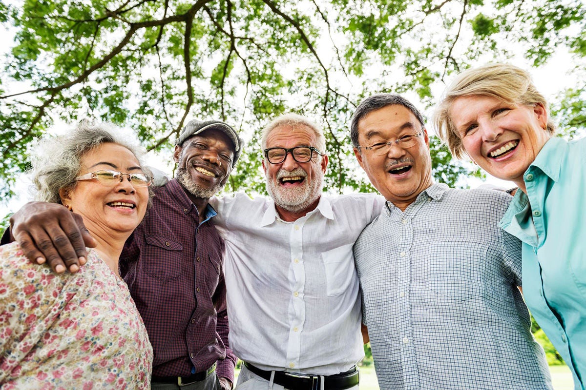 Older generation diverse people laughing together outside