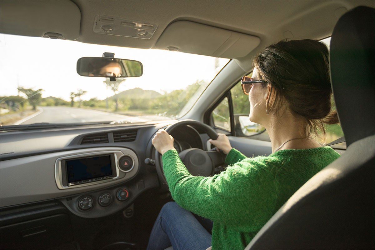 Woman driving a car in countryside