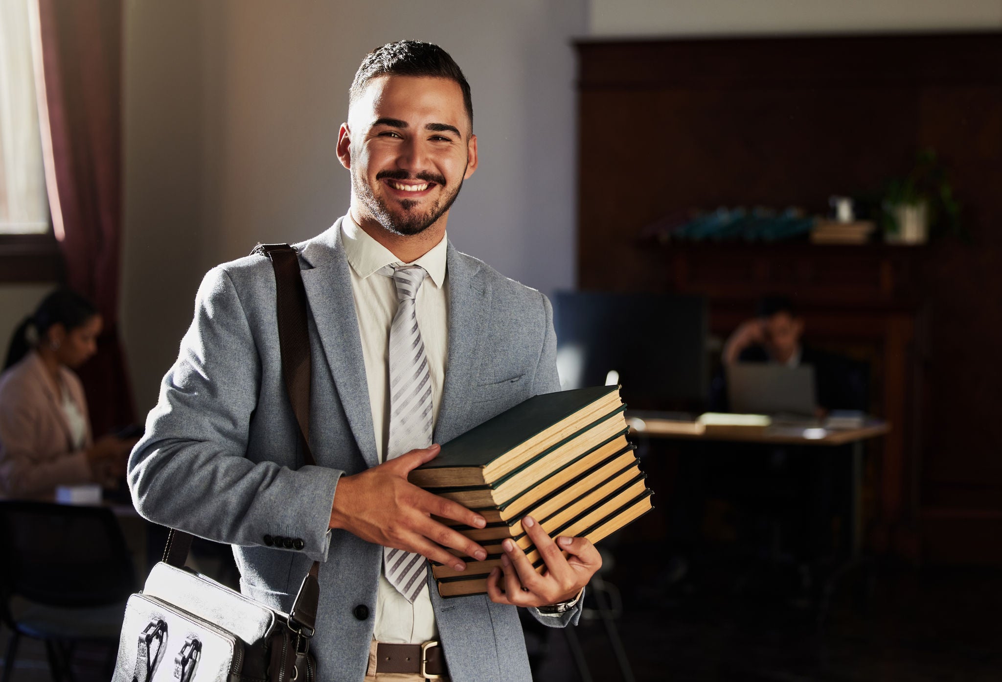 Lawyer holding books smiling