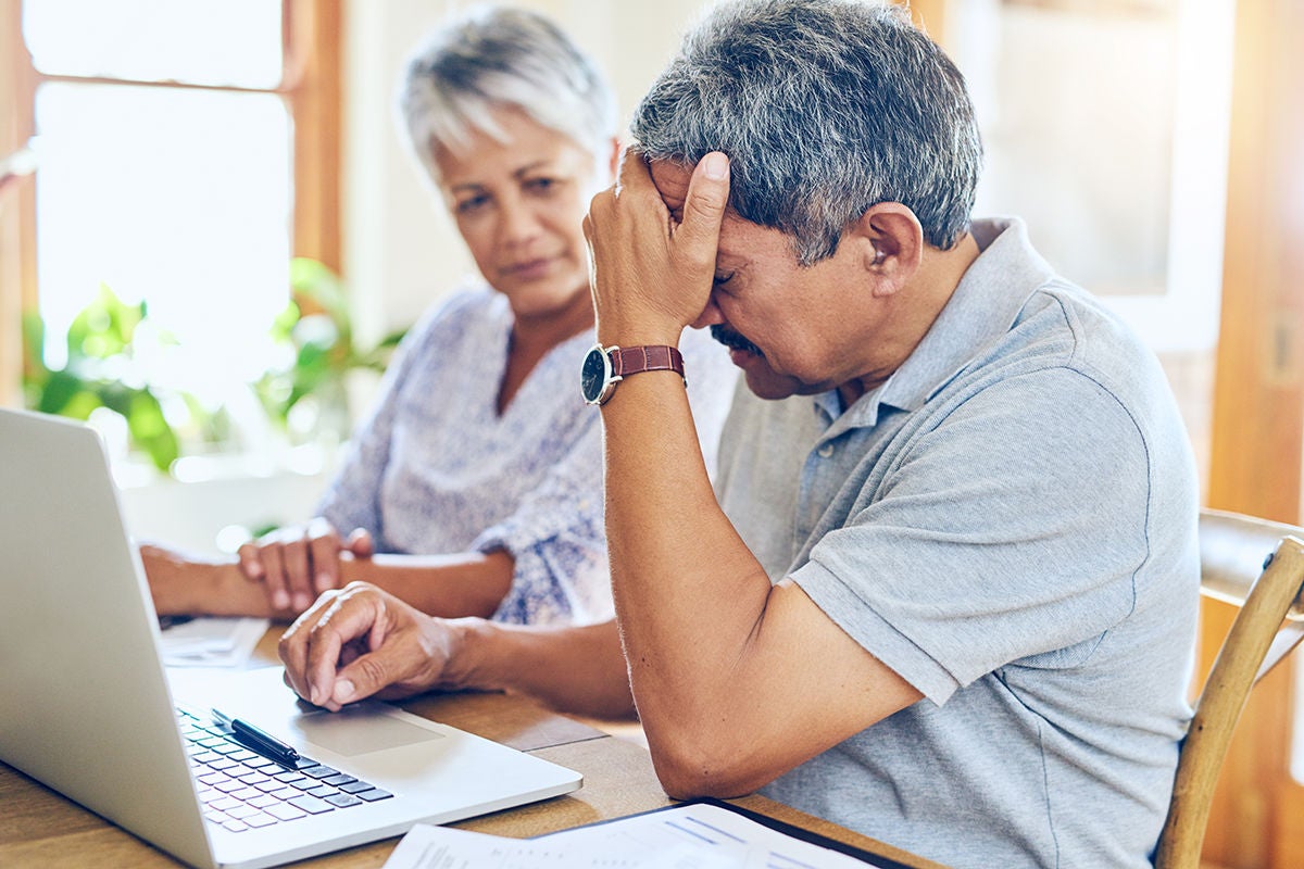 Finance, stress and senior couple with worry for bills, debt paperwork and documents for pension. Retirement, anxiety and elderly man and woman on laptop for mortgage payment, investment and budget.