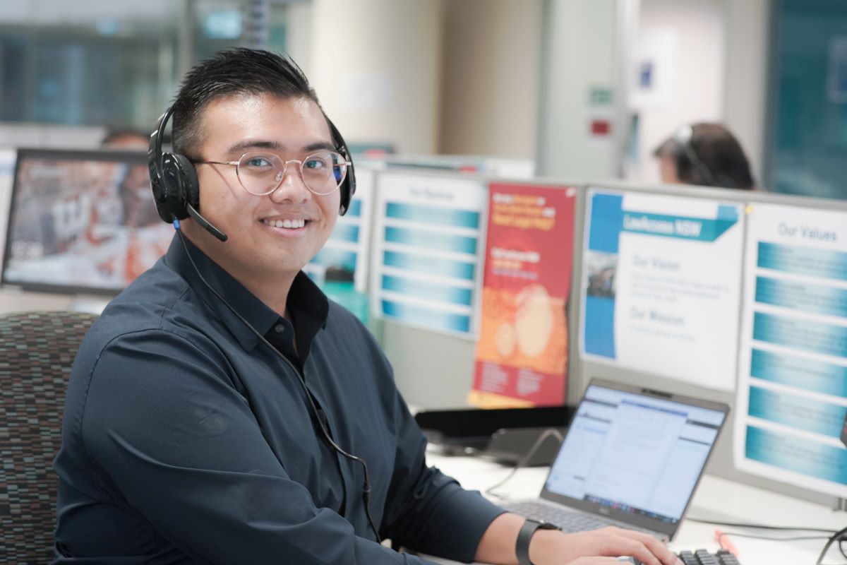 Man sitting with head set at a call centre